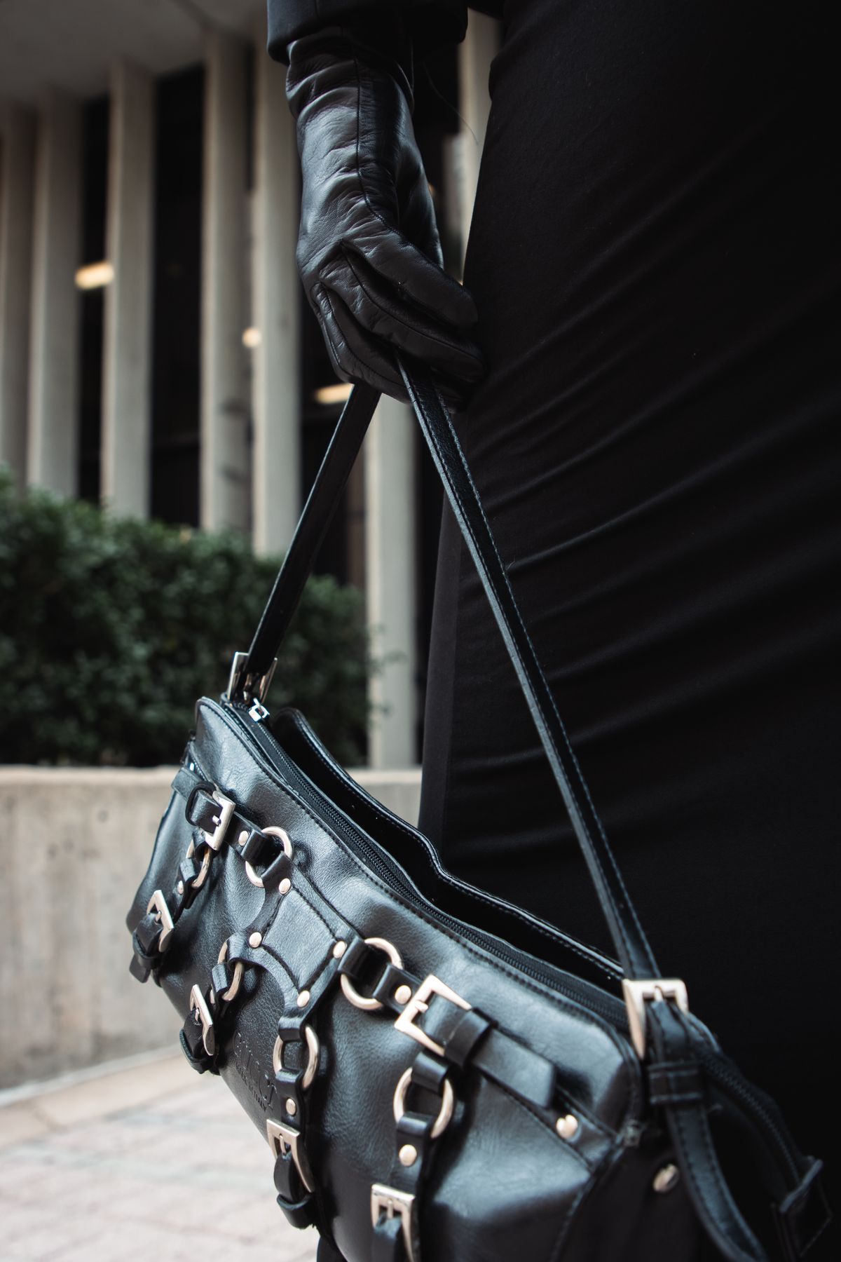 Fashion leather glove holding a structured leather bag